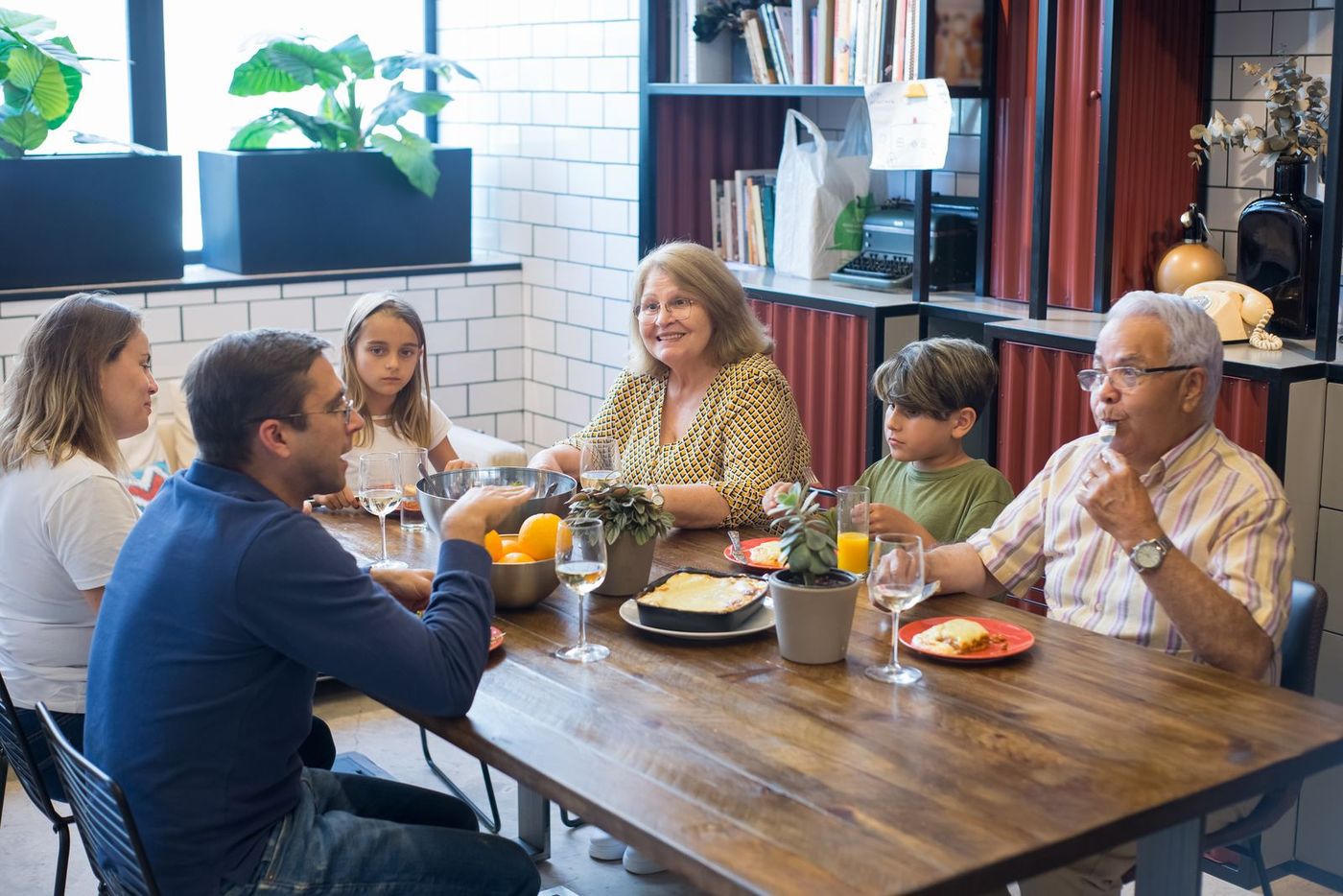 Three generations of a family sharing a meal at home